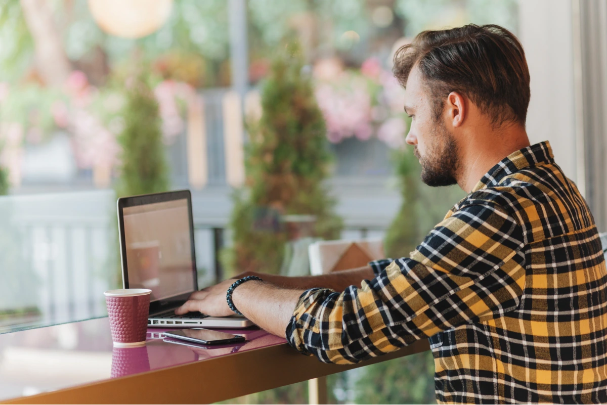 man-using-laptop-coffee-shop 1