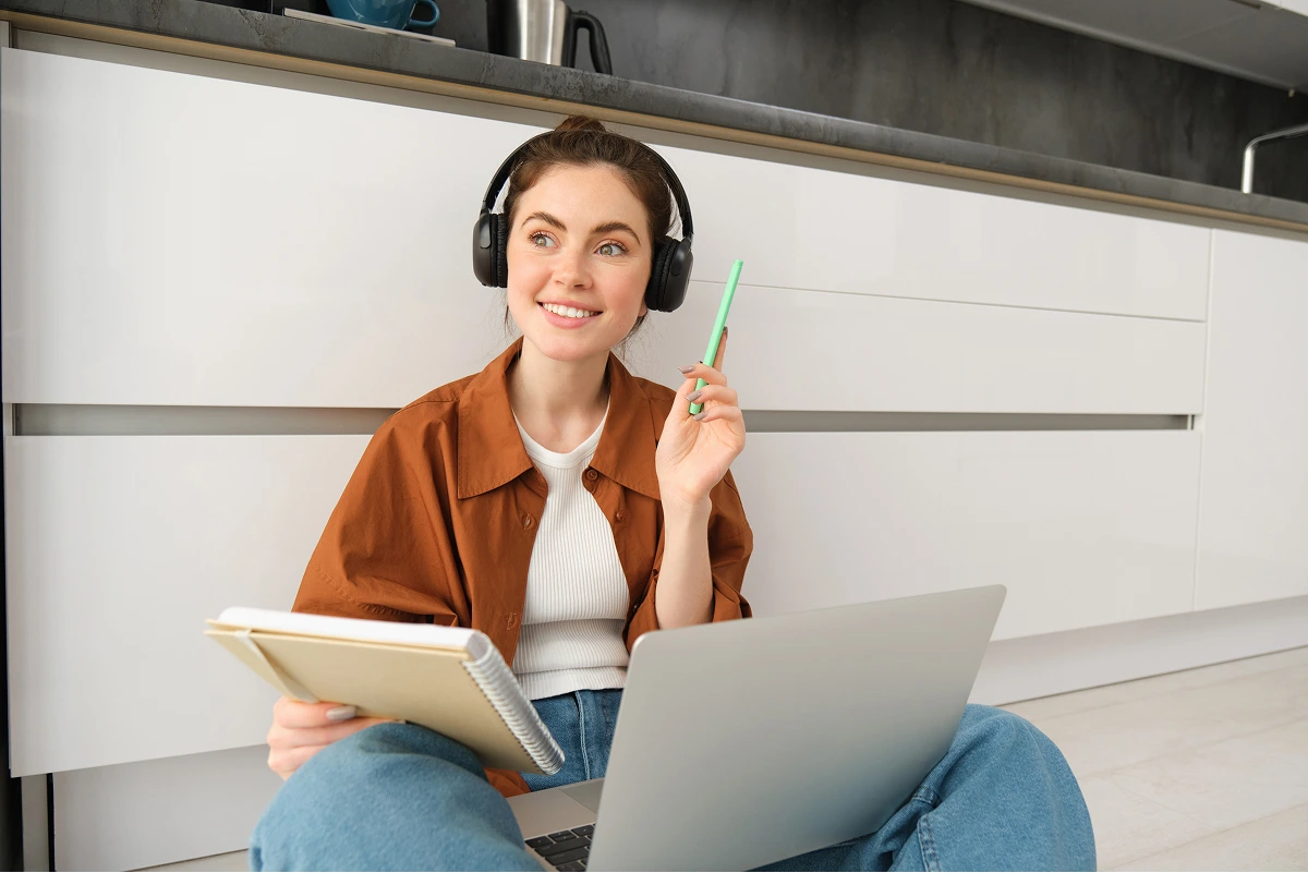 enthusiastic-young-woman-found-solution-looks-happy-sits-floor-does-homework-laptop 1 (1)