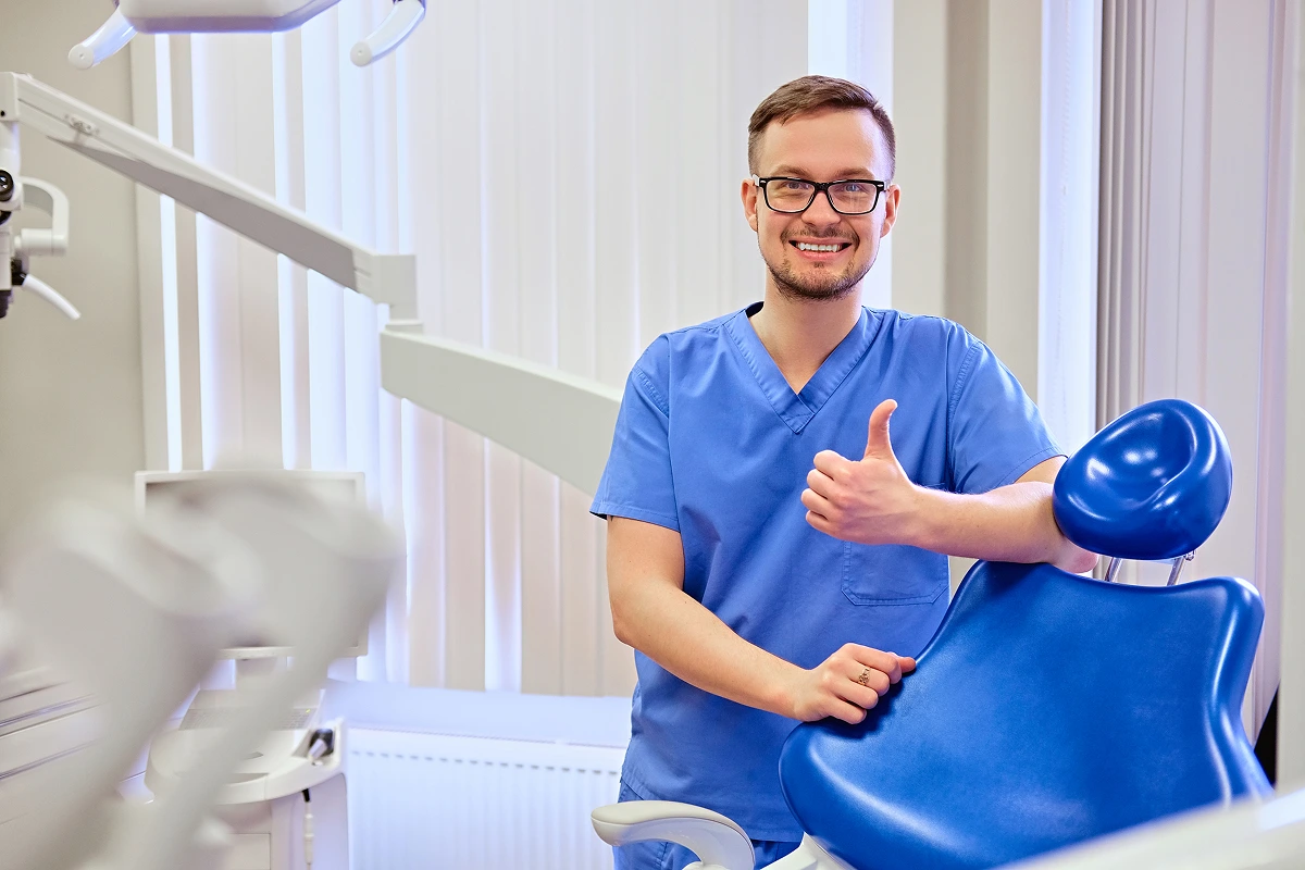 handsome-male-dentist-room-with-medical-equipment-background 1